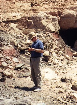 The author inspecting copper ore from the Burj Formation (early Mid Cambrian), Wadi Araba, Jordan.